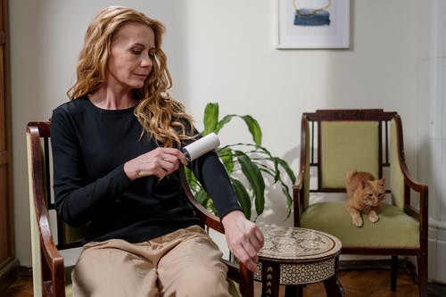 woman removing hair with roller